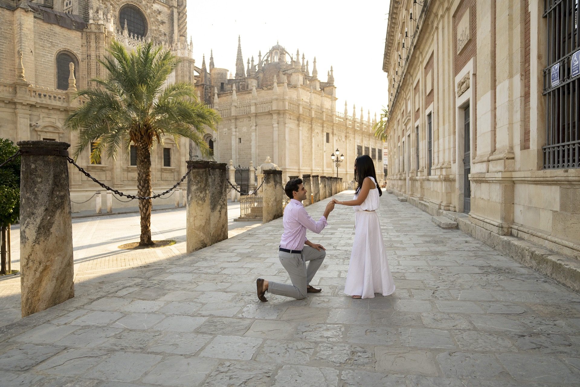 Surprise proposal on one knee by Seville Cathedral — proposal photographer Seville