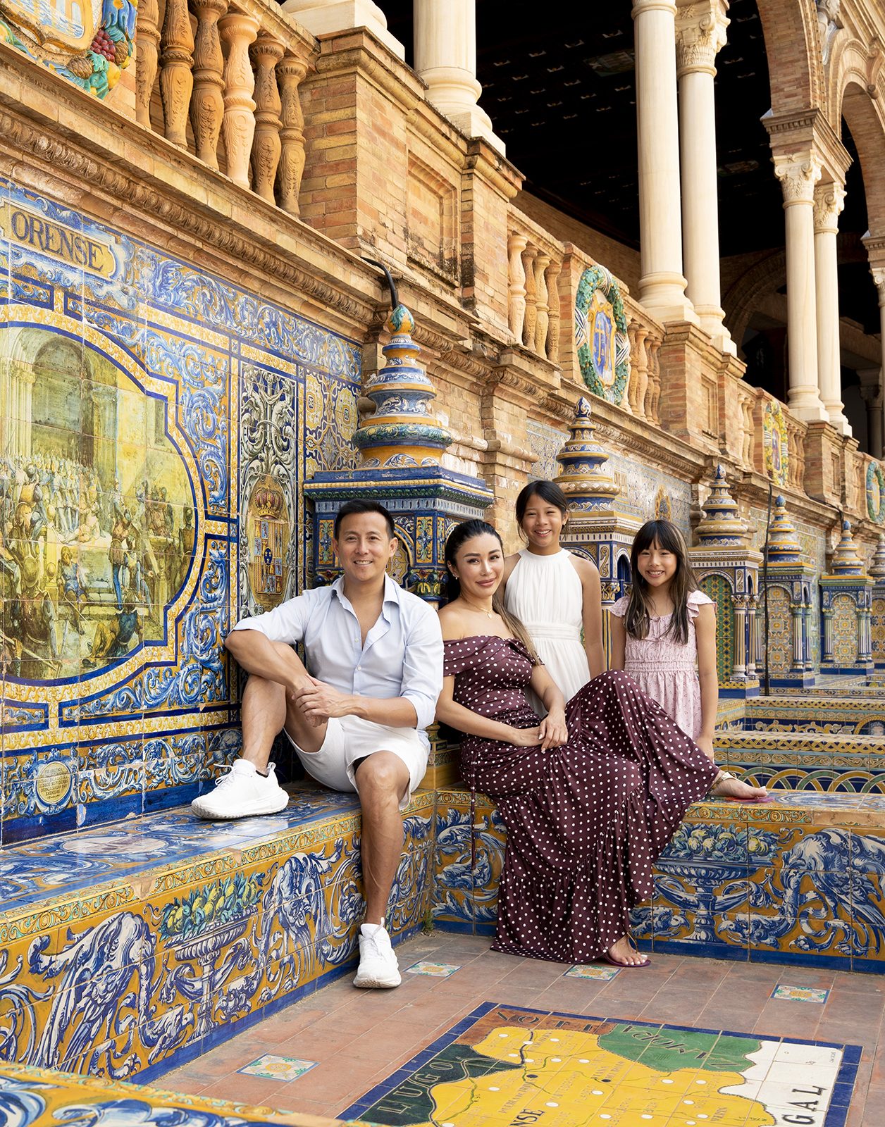 Relaxed family portrait on a Plaza de España bench