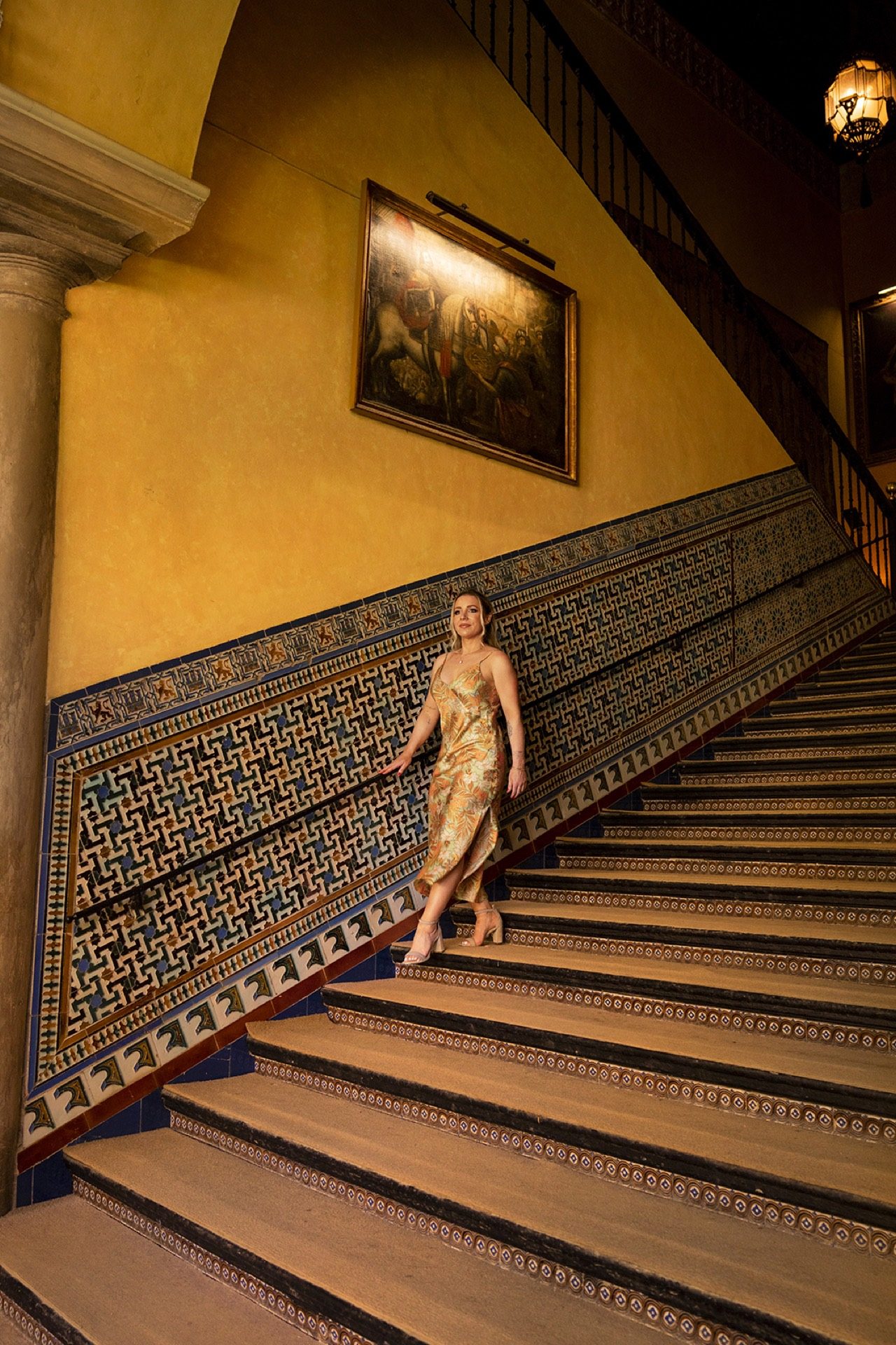 Editorial portrait on a tiled staircase in Seville