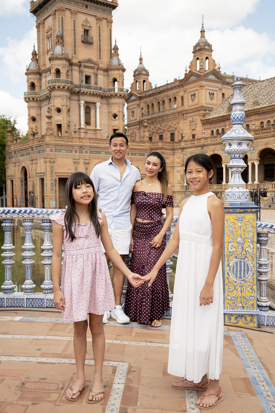 Family standing by the canal at Plaza de España, Seville