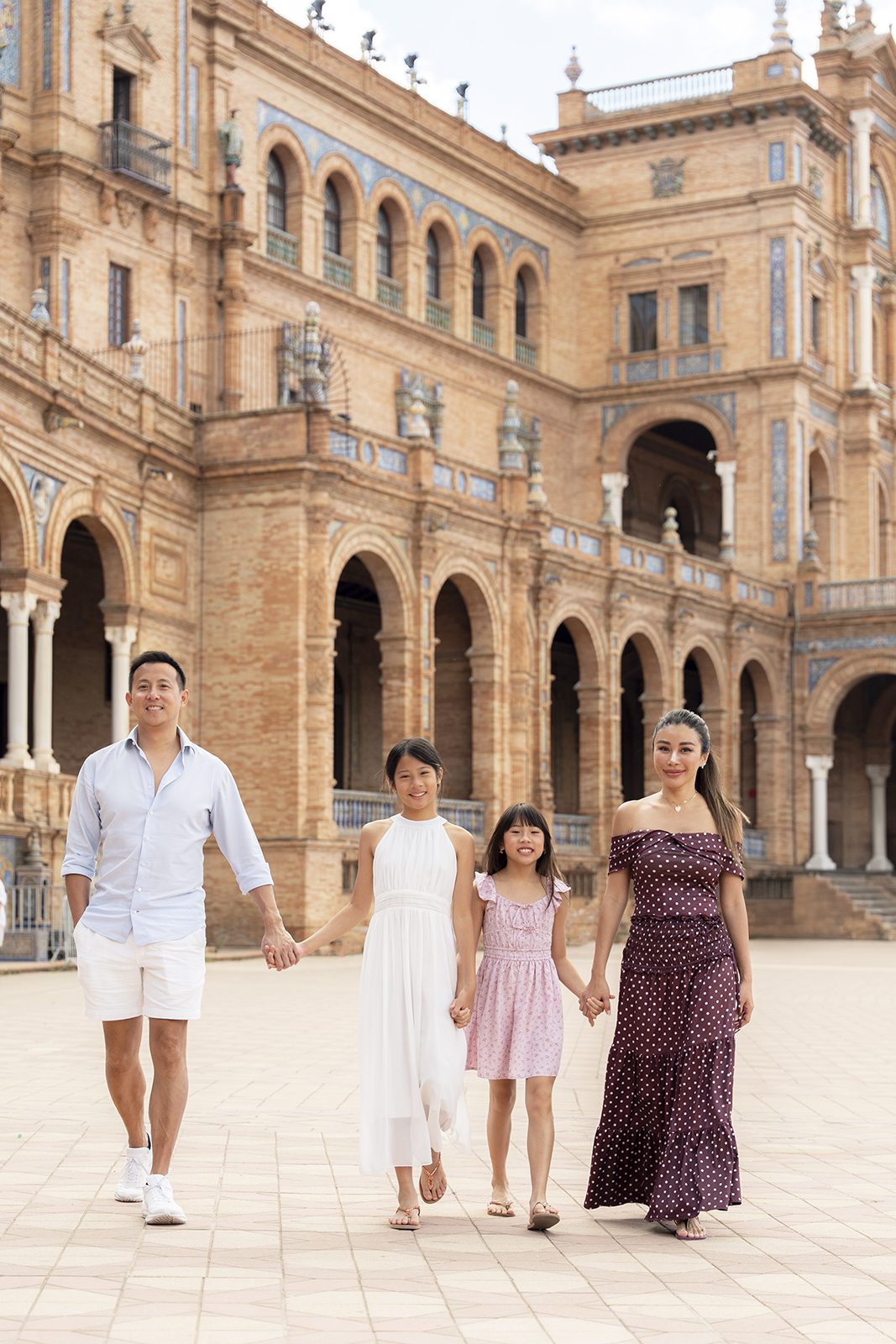 Family walking hand in hand at Plaza de España, Seville