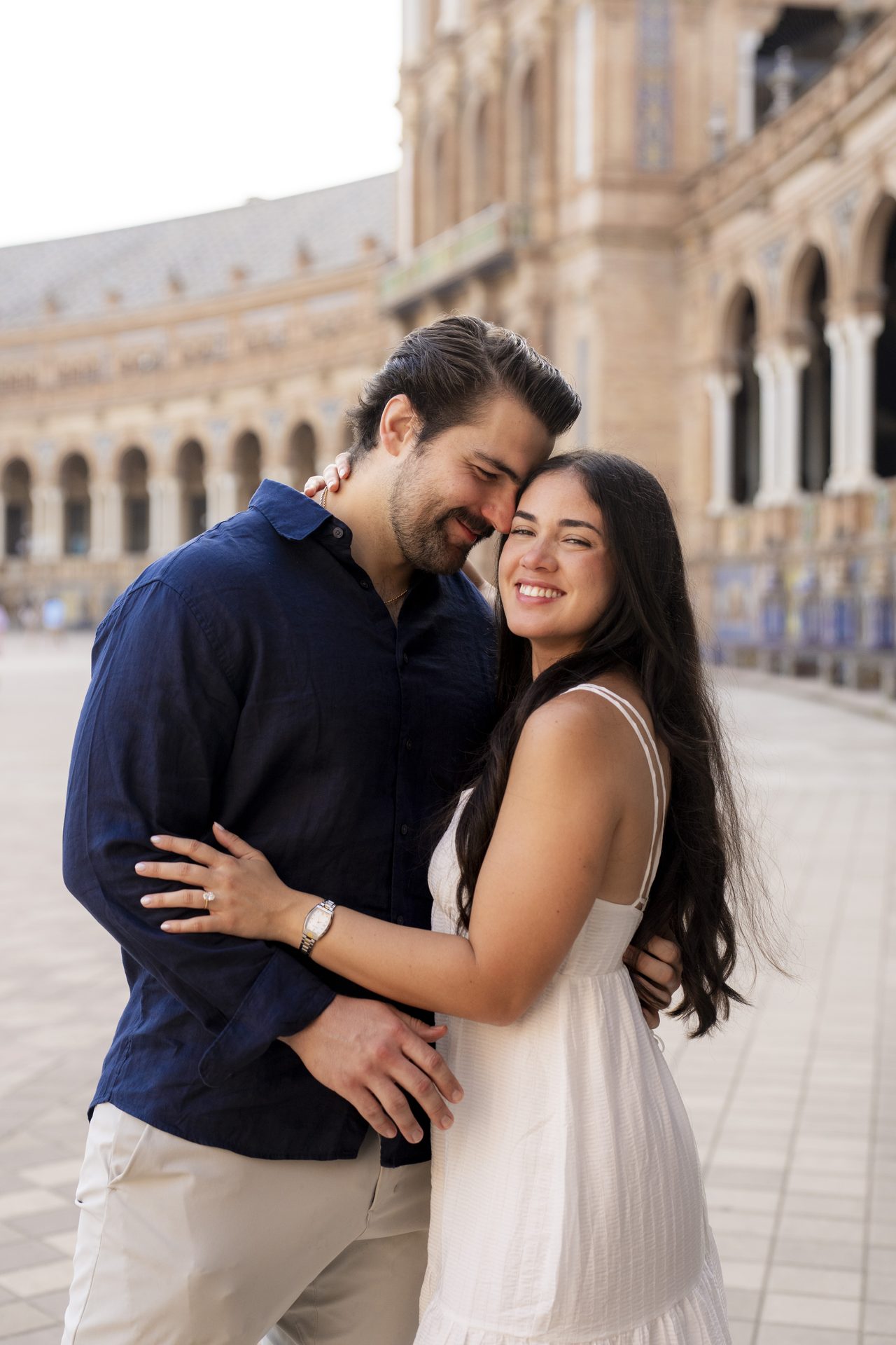 Engagement portrait in front of the arcades at Plaza de España, Seville