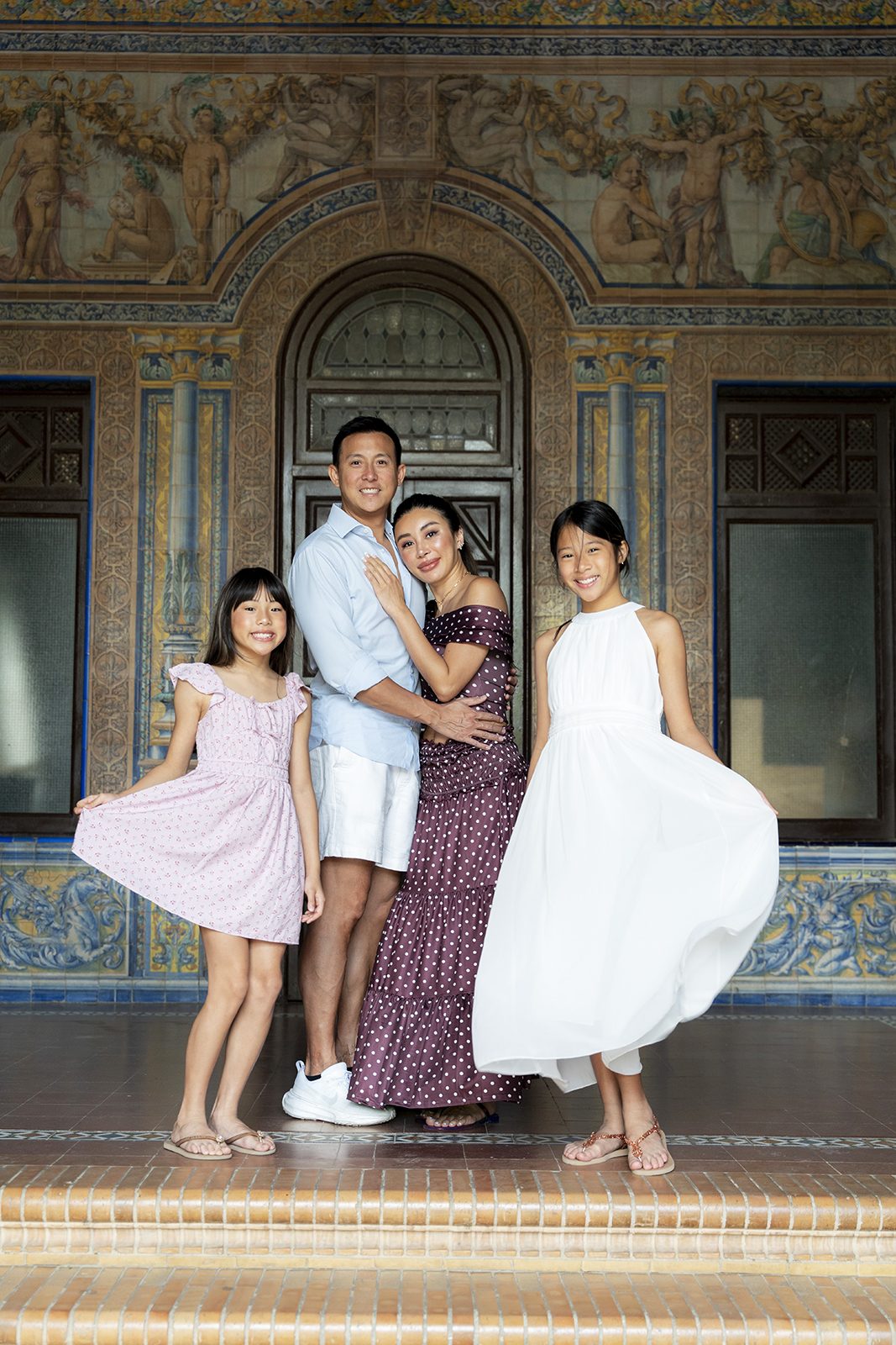 Family of four in front of the tiled archway at Plaza de España, Seville