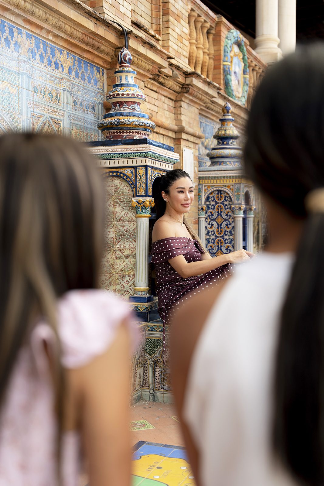 Mother photographed among the tiled alcoves at Plaza de España, Seville