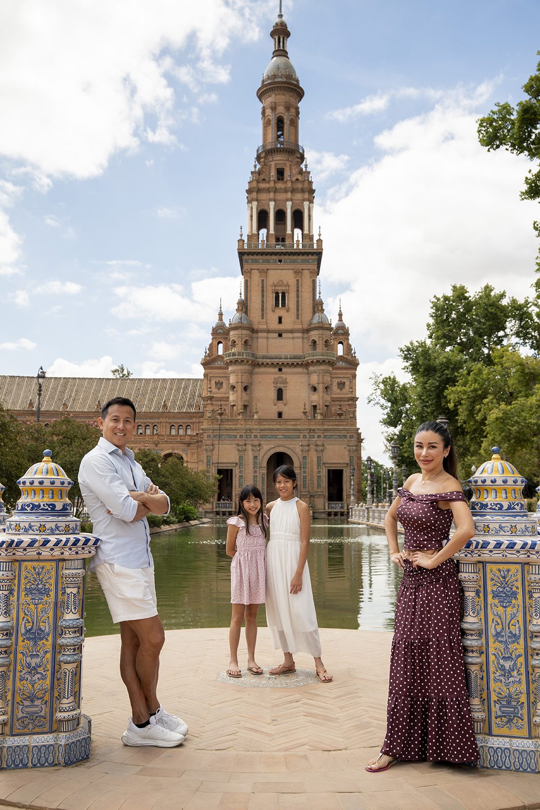 Family portrait by the canal and tower at Plaza de España, Seville
