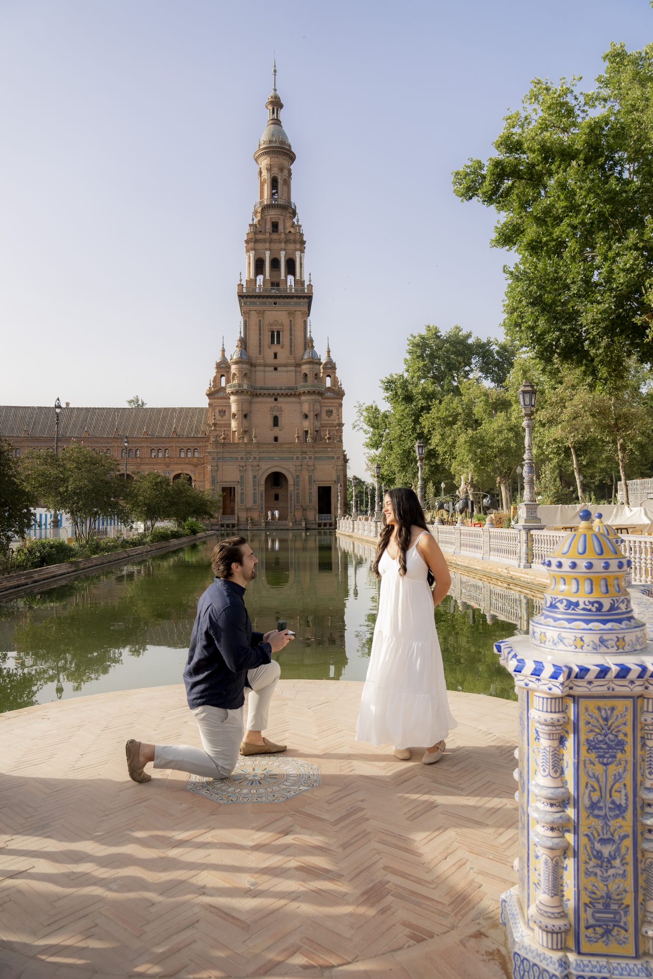 Marriage proposal on one knee beside the canal at Plaza de España, Seville